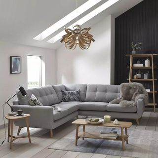 A grey corner sofa in a neutral living room