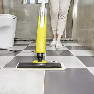 Karcher SC2 Upright Easyfix Steam Cleaner mop being used in a grey bathroom witch checked tiles