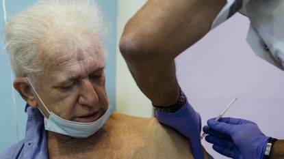 A man receives his Covid vaccine in an Israeli care home.
