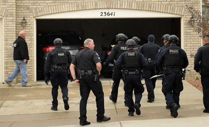 Officers from the Aurora Police Department taking part in a drug bust in the town in 2018 