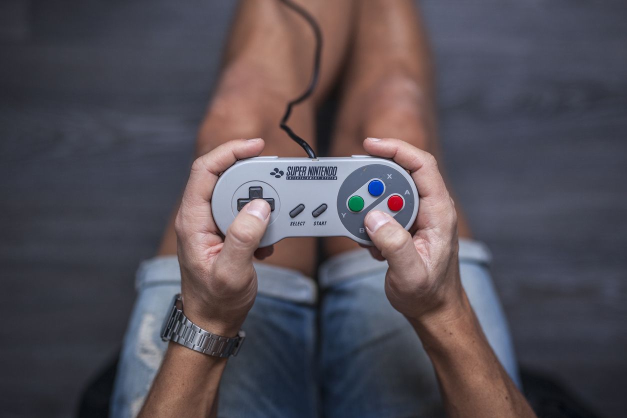 Man using SNES controller.