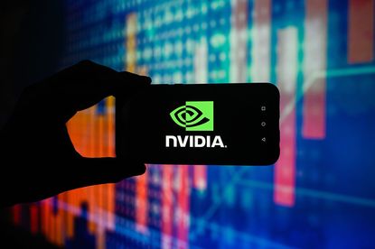  Nvidia logo is displayed on a smartphone with stock market percentages on the background
