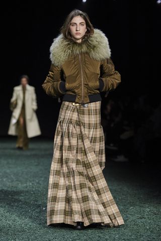Burberry model wearing brown jacket and plaid maxi skirt