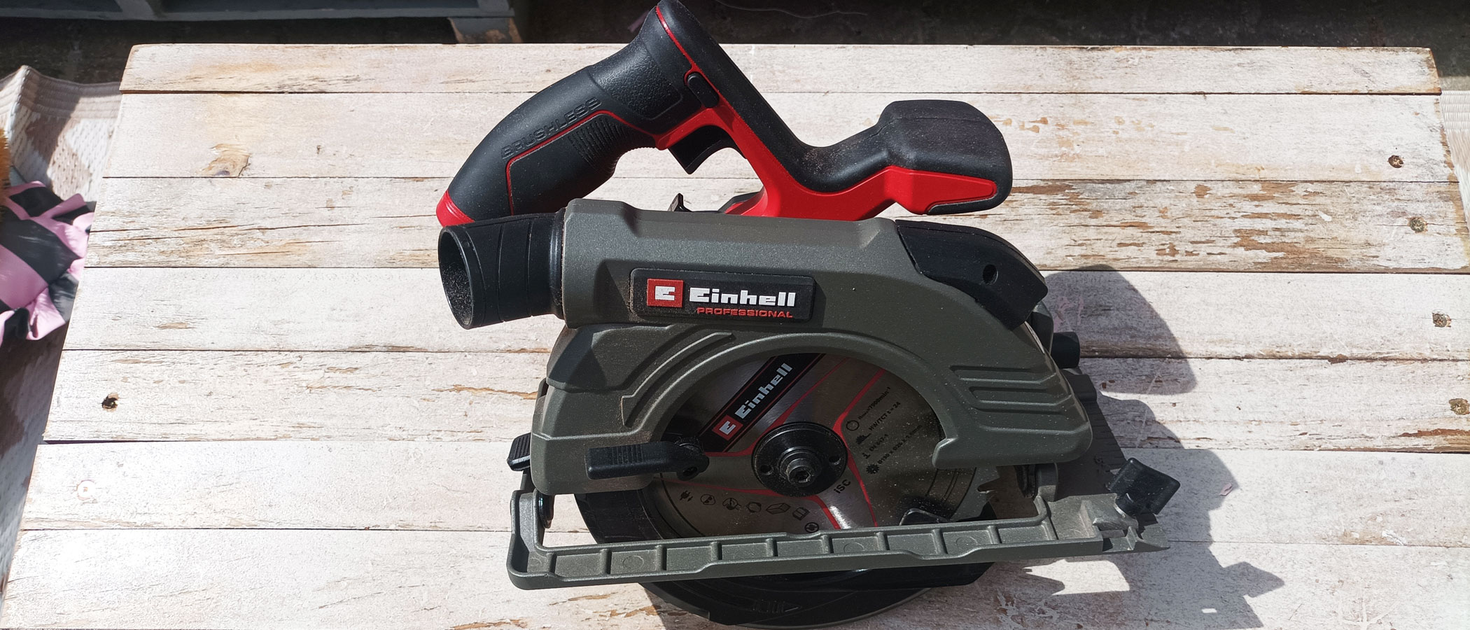 Red and grey Einhell PROFESSIONAL Cordless Circular Saw TP-CS 18/190 Li BL on whitewashed wood background