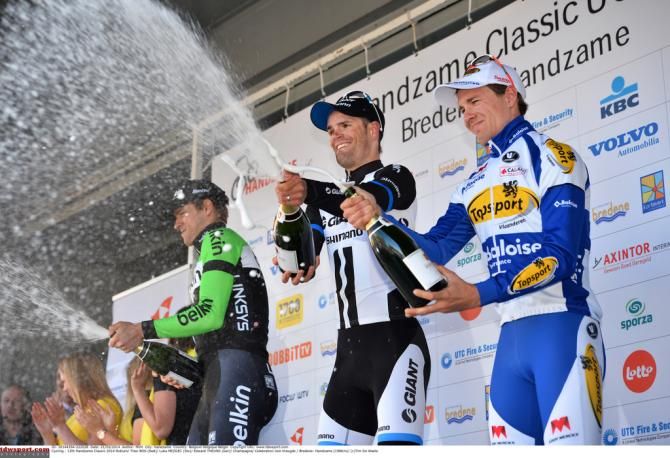 The podium placers give the crowd a spray of champagne
