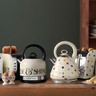 polka dotted kettle on wooden table toaster and egg cup