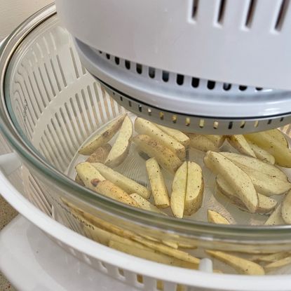 Image of halogen oven with uncooked chips 