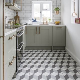 grey kitchen with copper handles and geometric floor tiles
