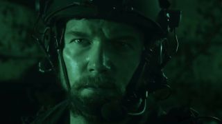 Chris Pratt prepared for combat and bathed in green light in The Terminal List.