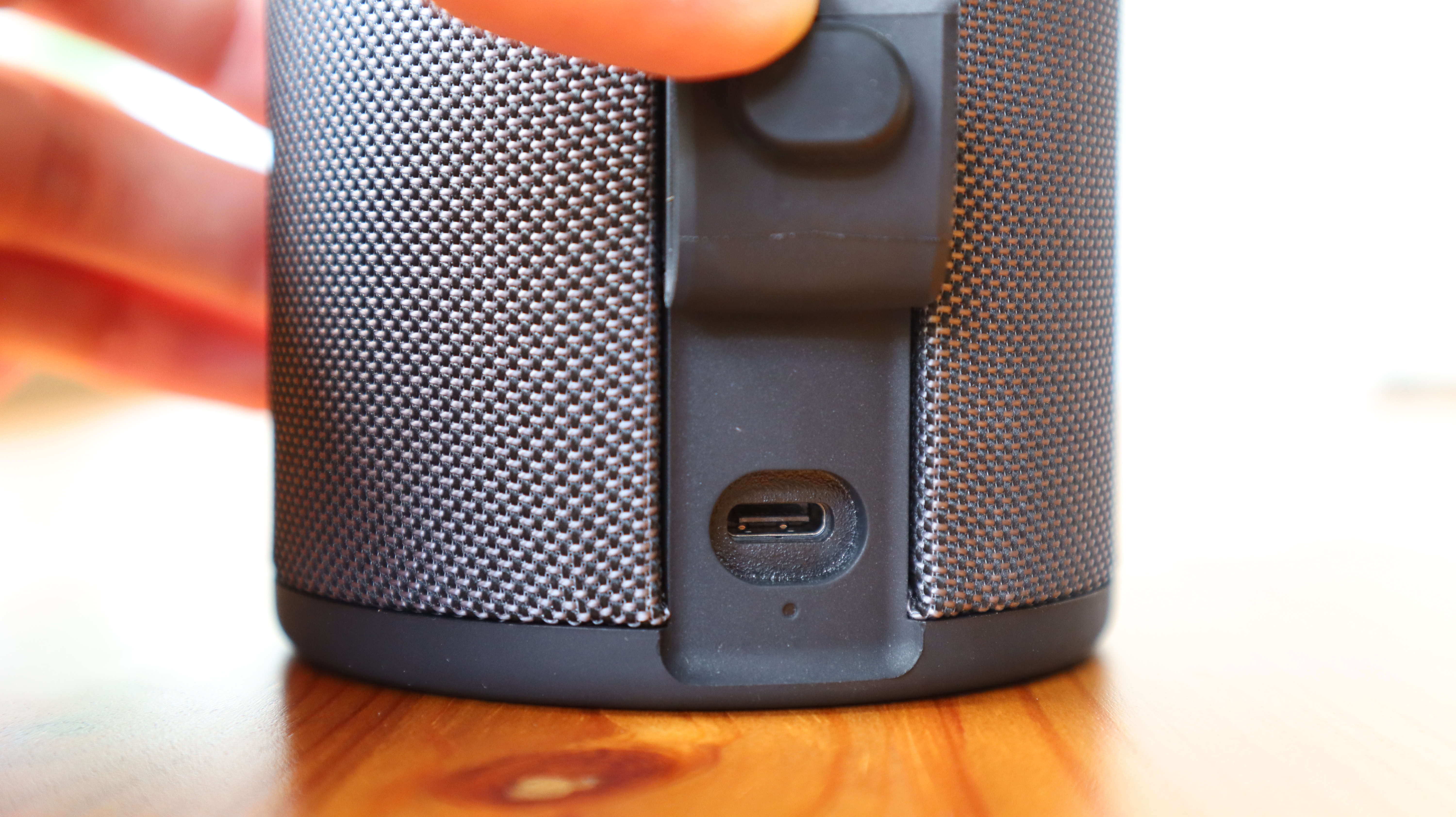 Ultimate Ears Megaboom 4 in black, in a house with white window frames in the background