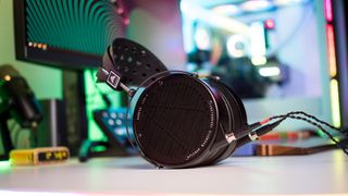 Audeze LCD-X lying flat on a table with RGB lighting