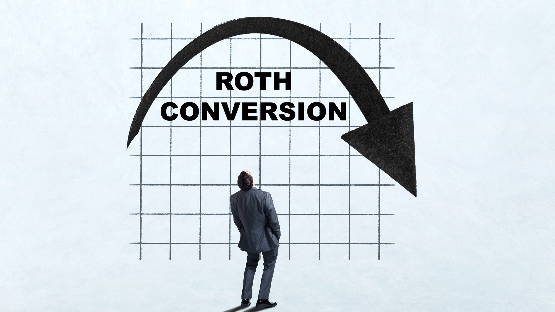 A man looks up as he ponders the benefits of making a Roth Conversion.