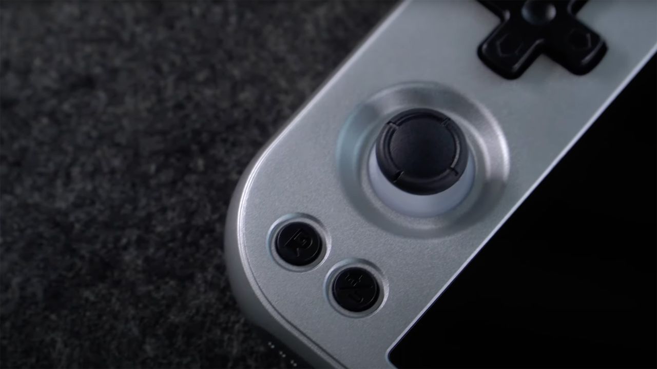Anbernic RG477M silver/gunmetal close-up on left joystick