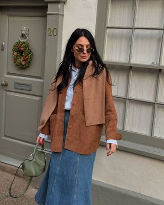 Claudia wears the brown suede jacket