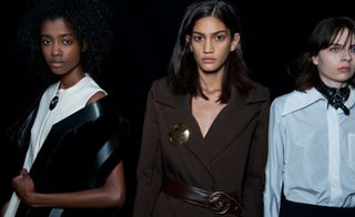 Models wearing a white structured dress, a brown coat with a leather belt, and a white shirt, from Thomas Tait A/W 2015 collection.