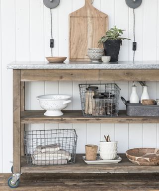 Rustic-industrial style console table on wheels with open shelving for kitchenalia