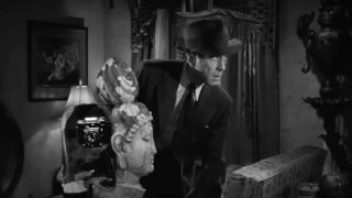 Humphrey Bogart as Philip Marlowe snooping around in The Big Sleep