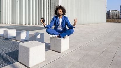 Man outside meditating