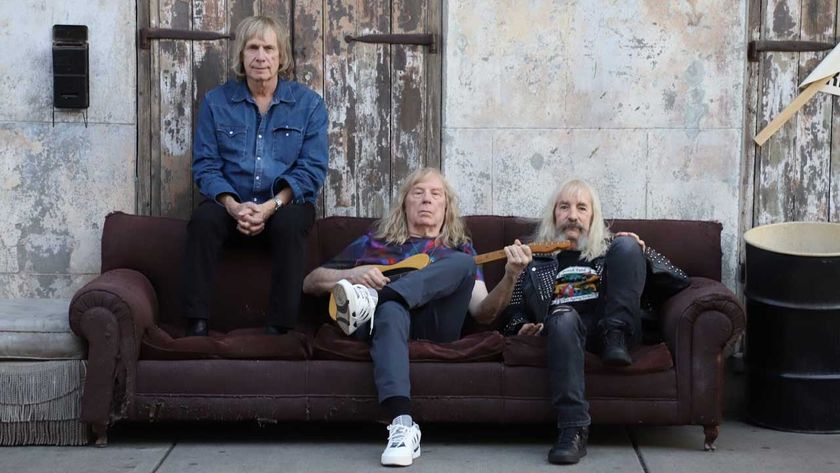 Spinal Tap seated on a sofa in the street 