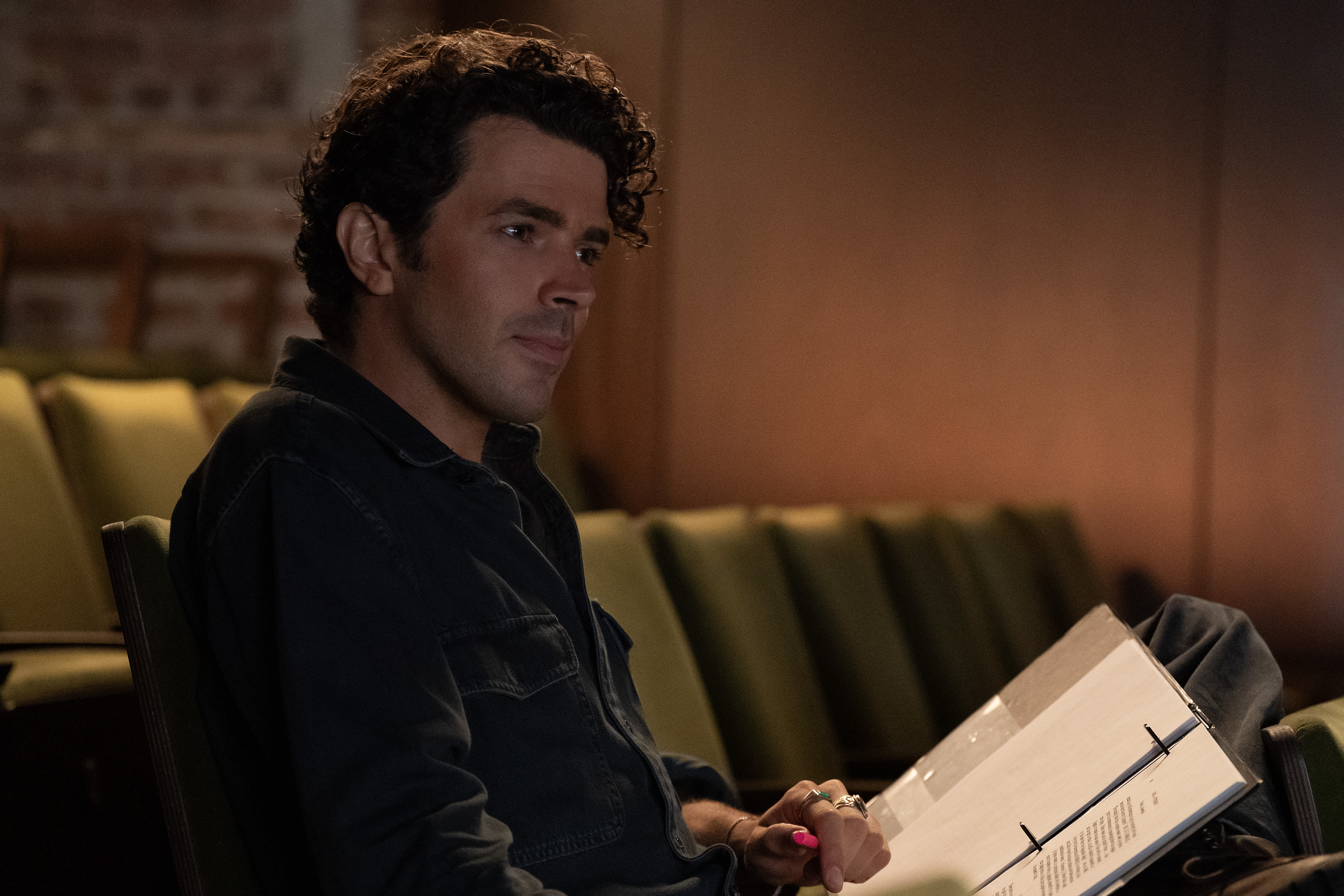 harry richardson as austin blanchett reading a script in a theater in not suitable for work