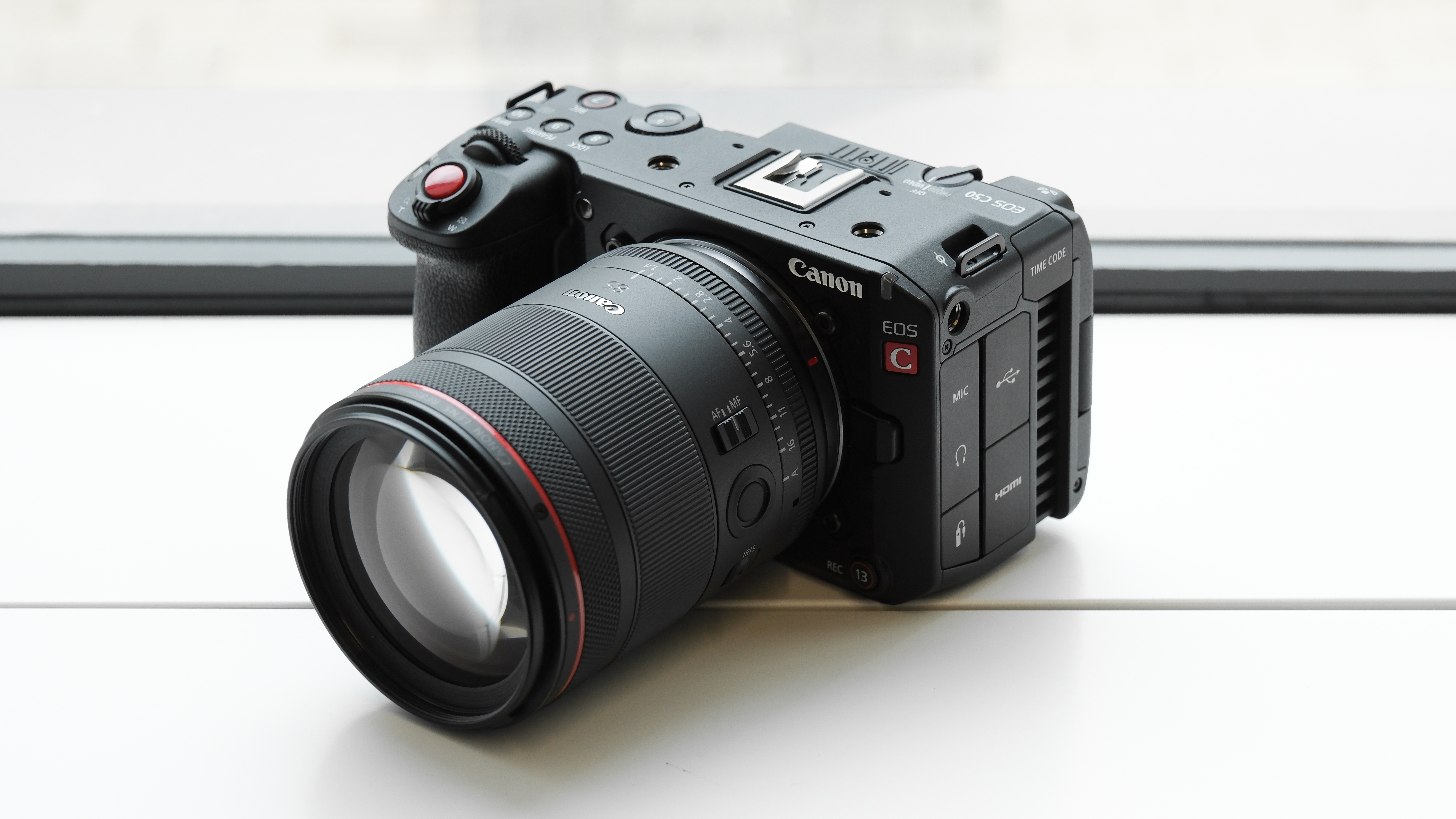 Canon EOS C50 with Canon RF 85mm f/1.4L VCM against a white background