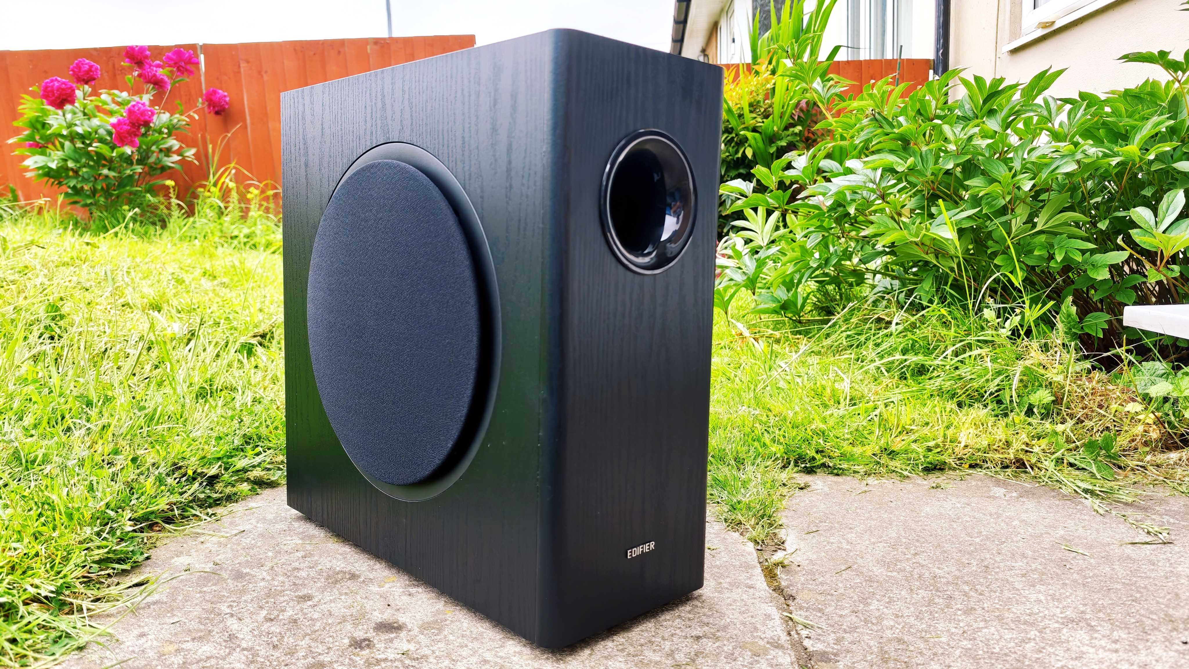 Edifier T5s subwoofer on a green garden lawn