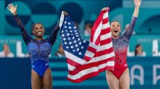 Gold medal winner Simone Biles of the United States and bronze medal winner Sunisa Lee celebrate their victory