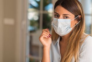 A person wearing a face mask indoors.