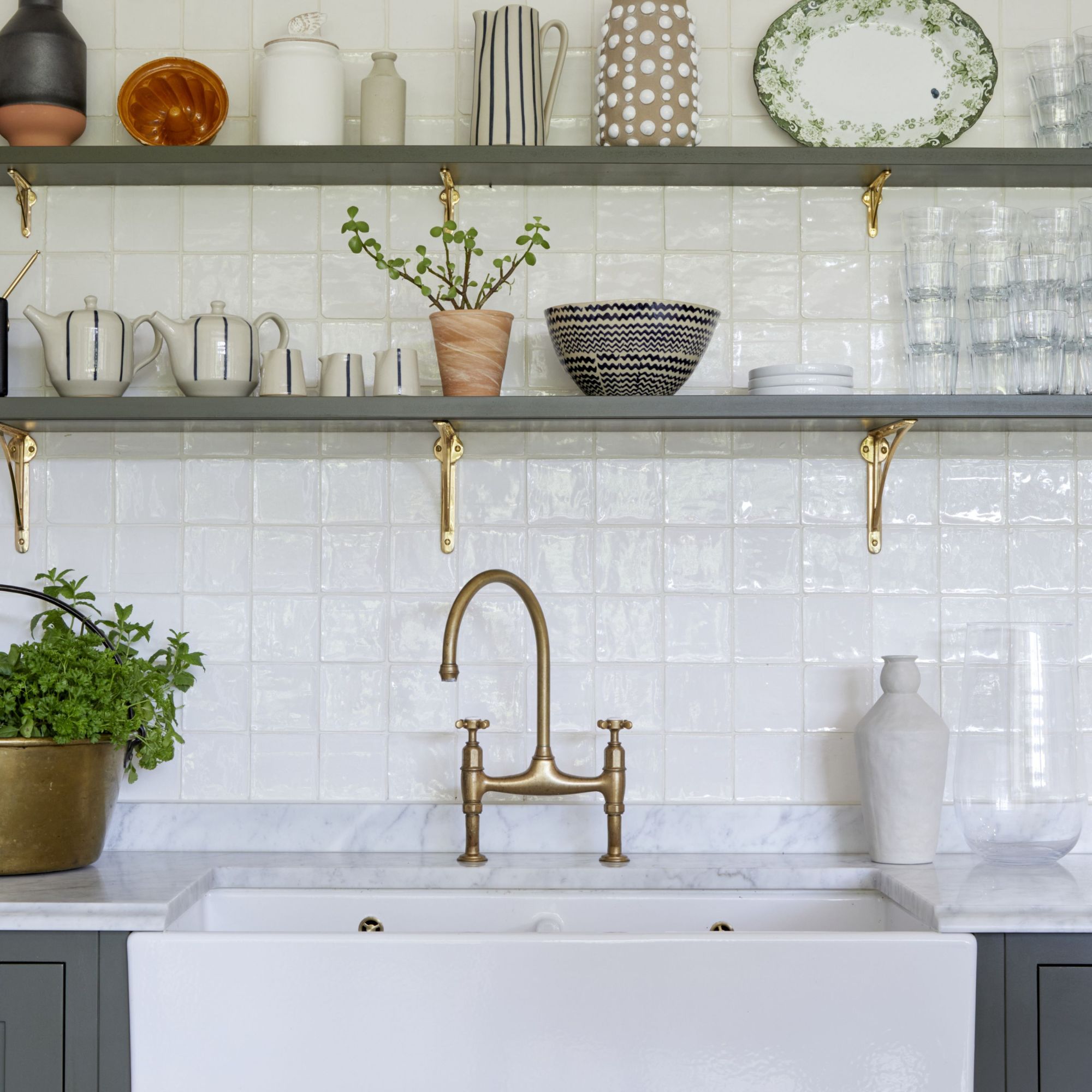 Grey shelving in a white kitchen with ornaments on them