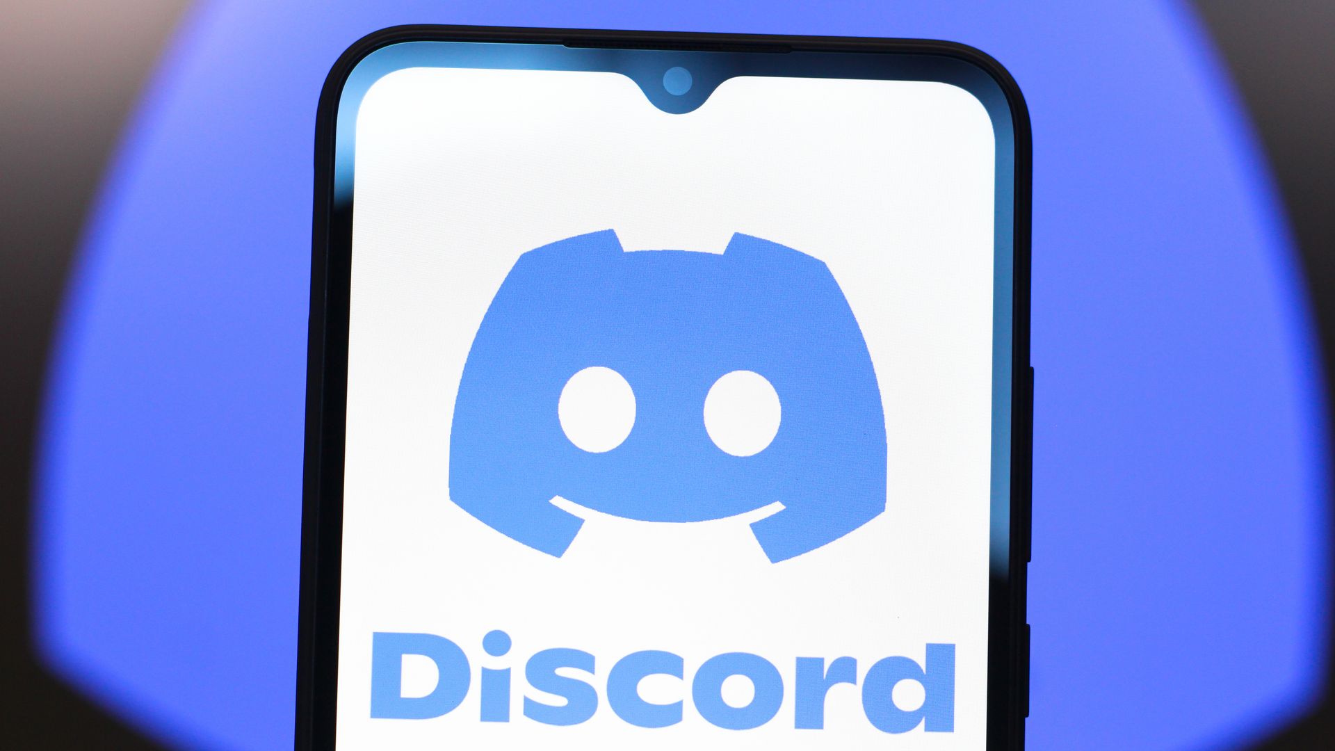 A phone showing the Discord app and logo