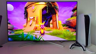 Philips Evnia 42M2N8900 monitor with Spyro the Dragon 2 gameplay on screen