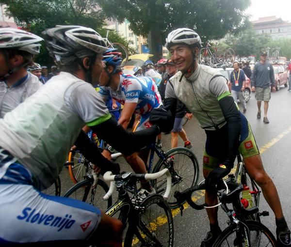 Slovenia celebrate a great win on a wet day in China.