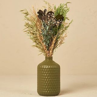 Dried flowers in green vase