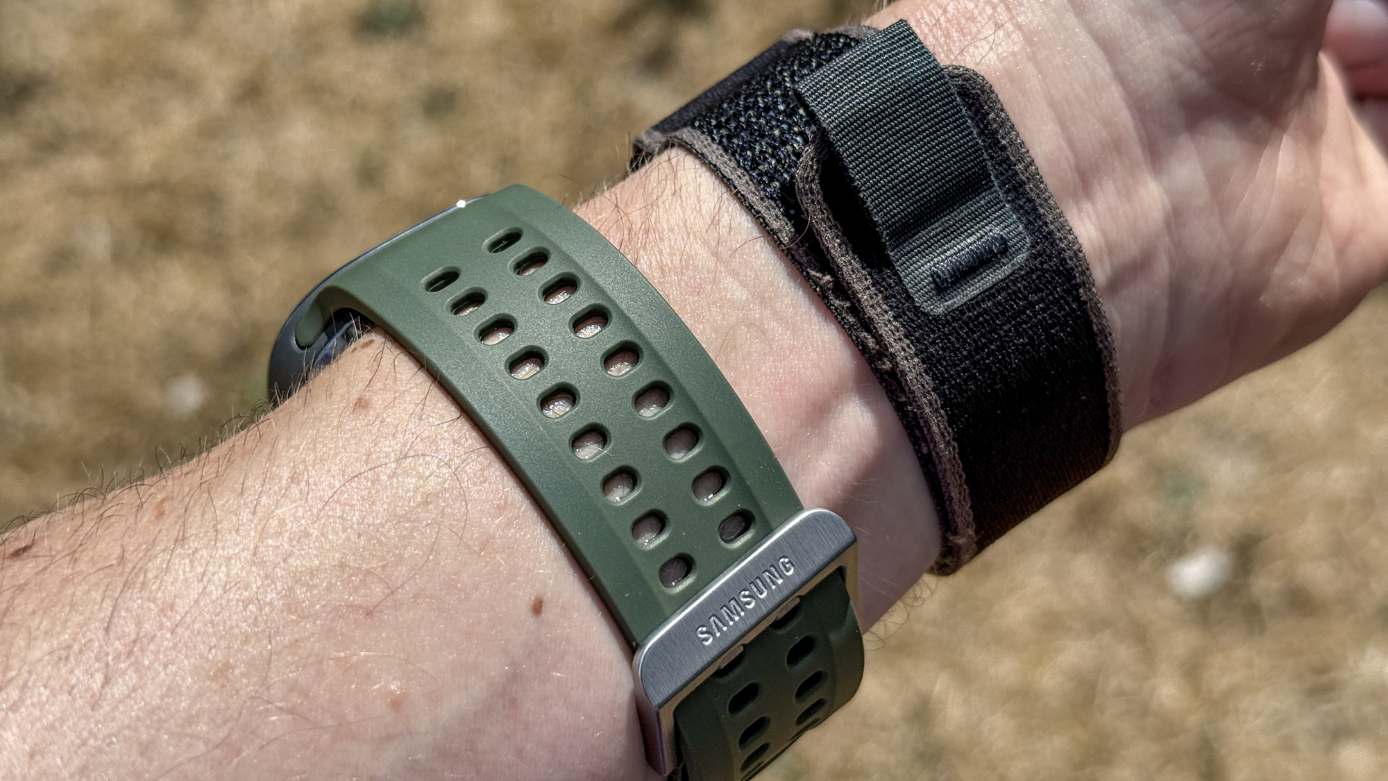 The Samsung Galaxy Watch Ultra 2 and Apple Watch Ultra 2 on a wrist outside