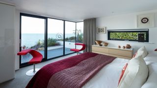 bedroom with sliding doors looking out to sea