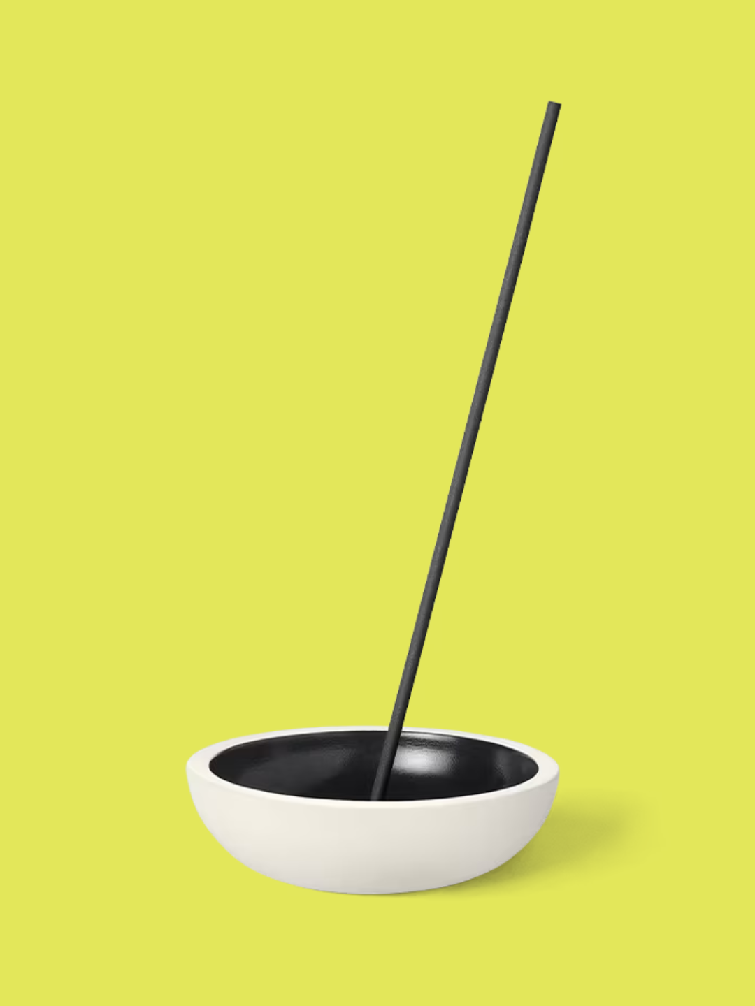 A dark amber incense stick in a round holder from Jo Malone London