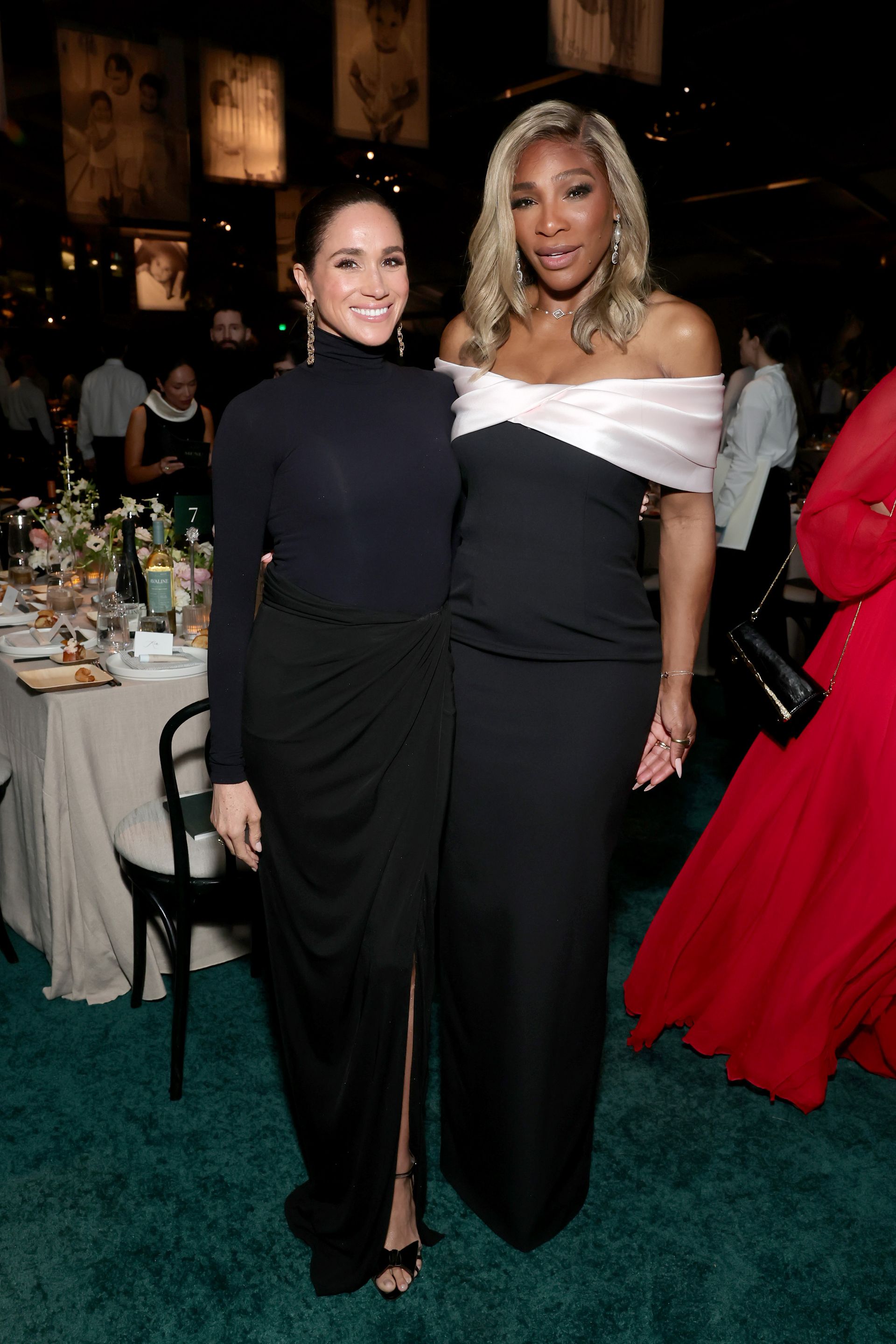 Meghan Markle wears a black turtleneck with a black maxi skirt and black bow heels.