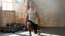 Man performing kettlebell lunges