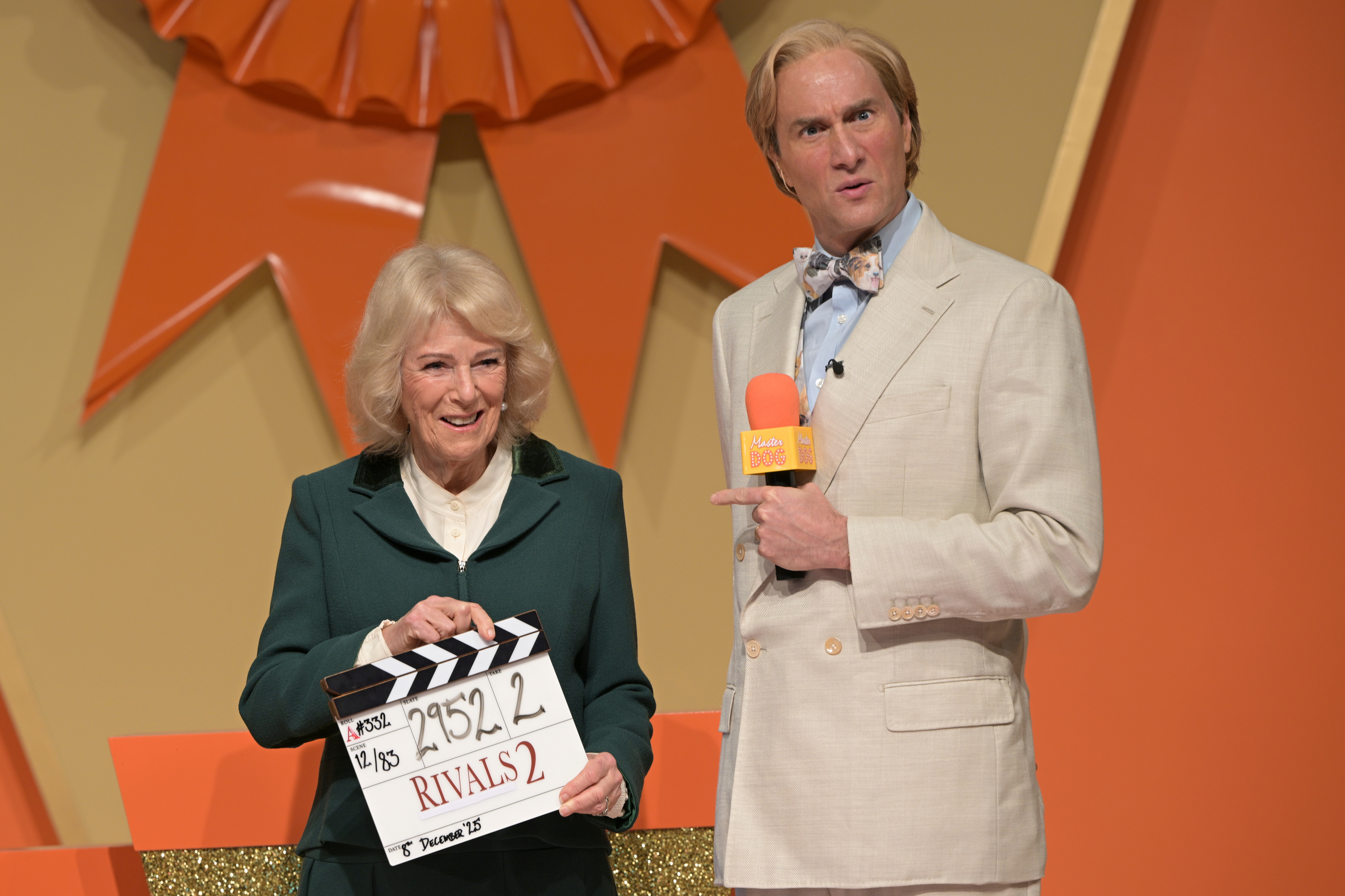 Queen Camilla holding a clapboard on set of Rivals