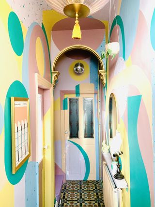 A hallway painted in bright tones like a mural