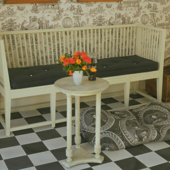 Hallway with flower in vase and wallpaper on wall