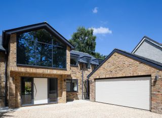 A modern home and garage with an electric garage door
