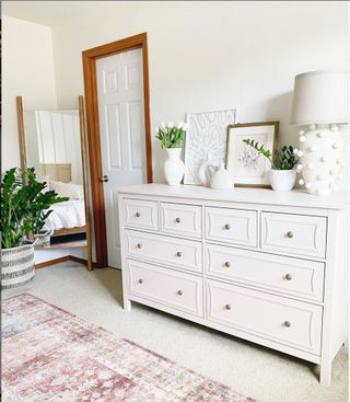 An IKEA chest of drawers painted white with overlay moulding