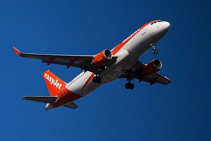 An EasyJet plane flies over Nantes, western France