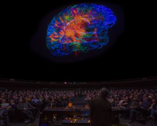Grateful Dead drummer Mickey Hart watches a visualization of his brain while performing the soundtrack of the planetarium show "Musica Universalis: The Greatest Story Ever Told."