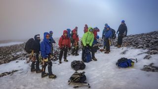 Hikers on the snowy summit of Ben Nevis