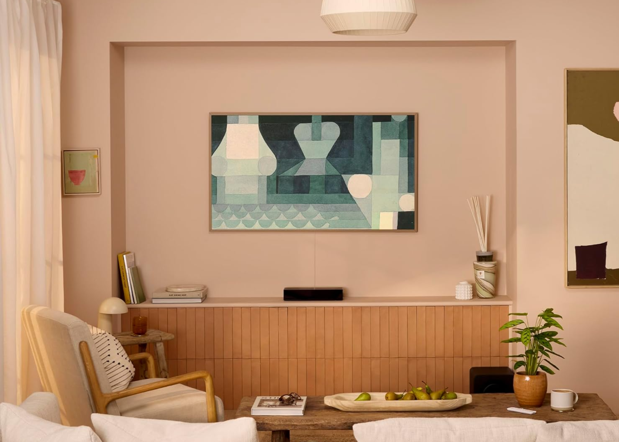 samsung frame tv on a wall in a modern living room centered in an alcove above an in-built base unit
