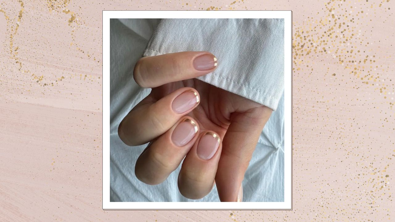 A close-up of a hand with gold chrome French tip nails by nail artist, Megan Rose (@gel.bymegan) on a white background/ and in a pastel pink and gold glitter template