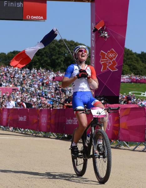 Julie Bresset (France) savours winning gold at the Olympic women's mountain bike race