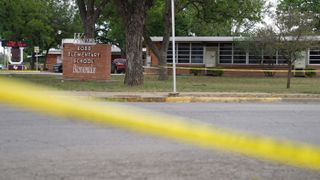 Sheriff crime scene tape is seen outside of Robb Elementary School in Uvalde, Texas, as state troopers guard the area on May 24, 2022, after a mass school shooter killed 19 children and two teachers.